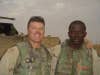 Then 1st Lt. James "Jimmy" Ryan, left, poses with Sgt. 1st Class Alwyn Cashe during their deployment to Forward Operating Base McKenzie in Samarra, Iraq. Cashe was injured Oct. 17, 2005, when an IED detonated next to his vehicle. Drenched in fuel, Cashe continued to pull his Soldiers from the burning vehicle, suffering burns to more than 80 percent of his body. He later died of his injuries, Nov. 8, 2005. Ryan, who recently retired as a major, served as a platoon leader in Company A, 1st Battalion, 15th Infantry Regiment, where Cashe was his platoon sergeant. (Courtesy photo provided by Retired Maj. James Ryan)