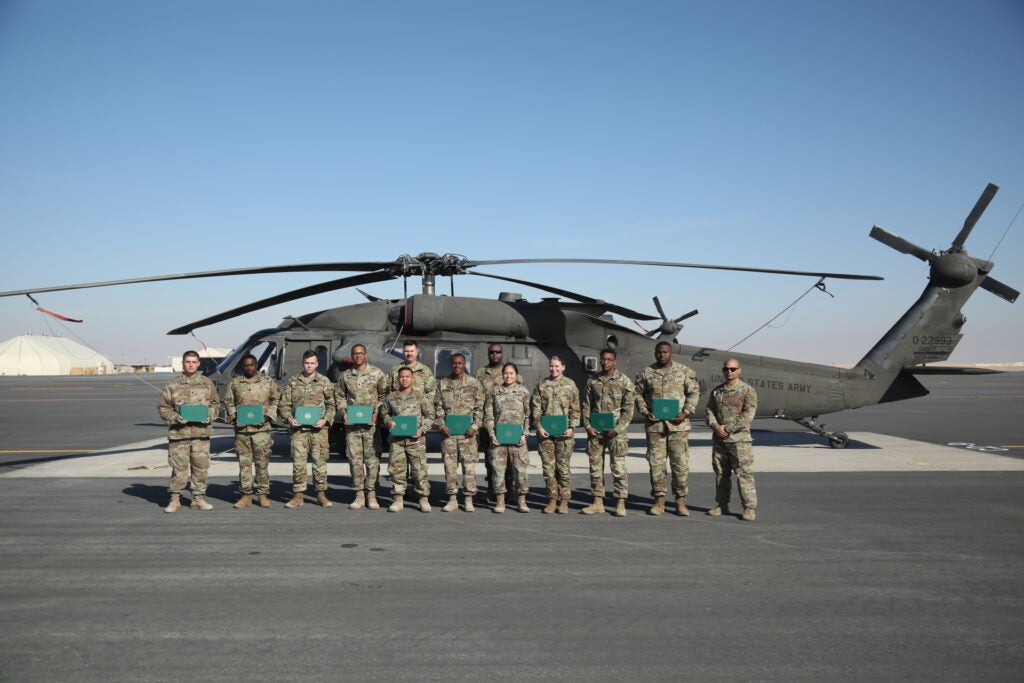 U.S. Army Soldiers, assigned to the 3rd Division Sustainment Brigade, participated in a re-enlistment ceremony at Camp Buehring, Kuwait Dec. 12, 2021. Before re-enlisting 3DSB Soldiers were given the opportunity to ride in a Boeing CH-47 Chinook as a reward for re-enlisting. (U.S. Army Photo by Cpl. Aaliyah Craven)