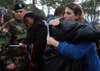 Kasinal Cashe, left, crys on the shoulder of a unidentifed soldier Thursday, Dec. 15, 2005, for her brother U.S. Army Sgt. 1st Class Alwyn Cashe of Oviedo, Fla., along with Vicki Taylor, right, while at a tree dedication ceremony in Fort Stewart, Ga. Cashe died in Iraq from wounds he suffered while rescuing other soldiers trapped inside a Bradley Fighting Vehicle that was destroyed by a roadside bomb. The tree dedication ceremony was the second largest for those killed in action while serving with the Army's 3rd Infantry Division. (AP Photo/Stephen Morton)