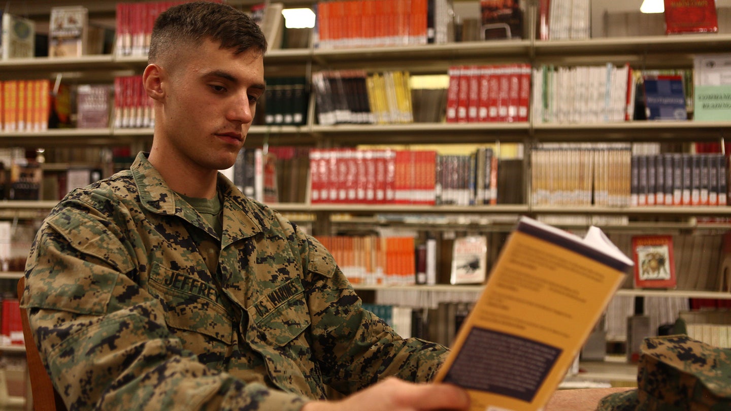 Lance Cpl. Sterling Jeffrey, a data network specialist with Marine Wing Communications Squadron 38 and a Springdale, Ark., native, reads “First to Fight: an inside view of the U.S. Marine Corps,” at the library aboard Marine Corps Air Station Miramar, Calif.