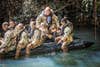 A soldier jumps out of a boat during competitive tactical events at Schofield Barracks, Hawaii, April 8, 2021. The three-day series of events were designed to build cohesive teams. (Photo / Army Spc. Jessica Scott)