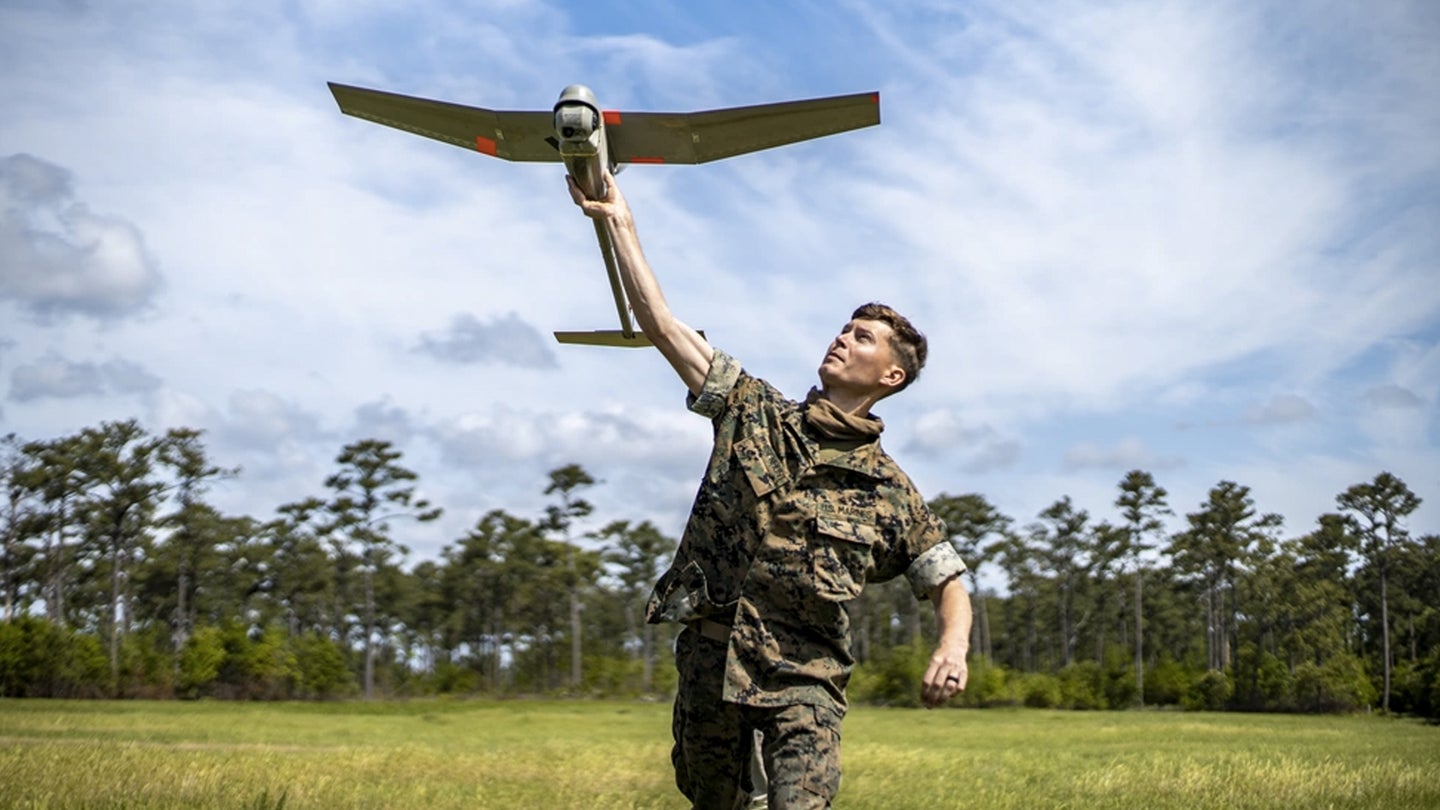 Cpl. Nicholas Whisenhunt, an engineer equipment operator with Special Purpose Marine Air-Ground Task Force - Southern Command, launches an RQ-11B Raven for flight during an RQ-11B Raven Operator Course at Marine Corps Base Camp Lejeune, North Carolina, April 27, 2020 (U.S. Marine Corps photo by Sgt. Andy O. Martinez)
