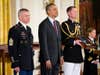 Command Sgt. Maj. Michael Grinston, left, stands with President Barack Obama before accepting the Medal of Honor on behalf of Sgt. Candelario Garcia, during a ceremony in the East Room of the White House on Tuesday, March 18, 2014, in Washington. Obama awarded 24 Army veterans the Medal of Honor for conspicuous gallantry in recognition of their valor during major combat operations in World War II, the Korean War and the Vietnam War. (AP Photo/Manuel Balce Ceneta)