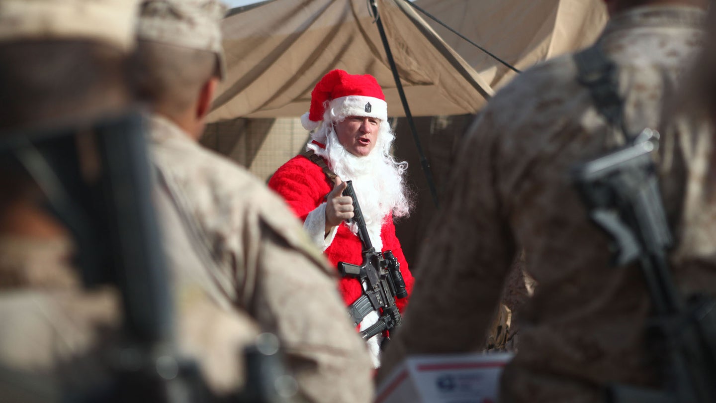 Sgt. Maj. Larry J. Harrington, the sergeant major of 1st Battalion, 6th Marine Regiment, briefs Marines in December 2011 in Sangin, Afghanistan while wearing a Santa Claus costume. (U.S. Marine Corps photo by James Clark