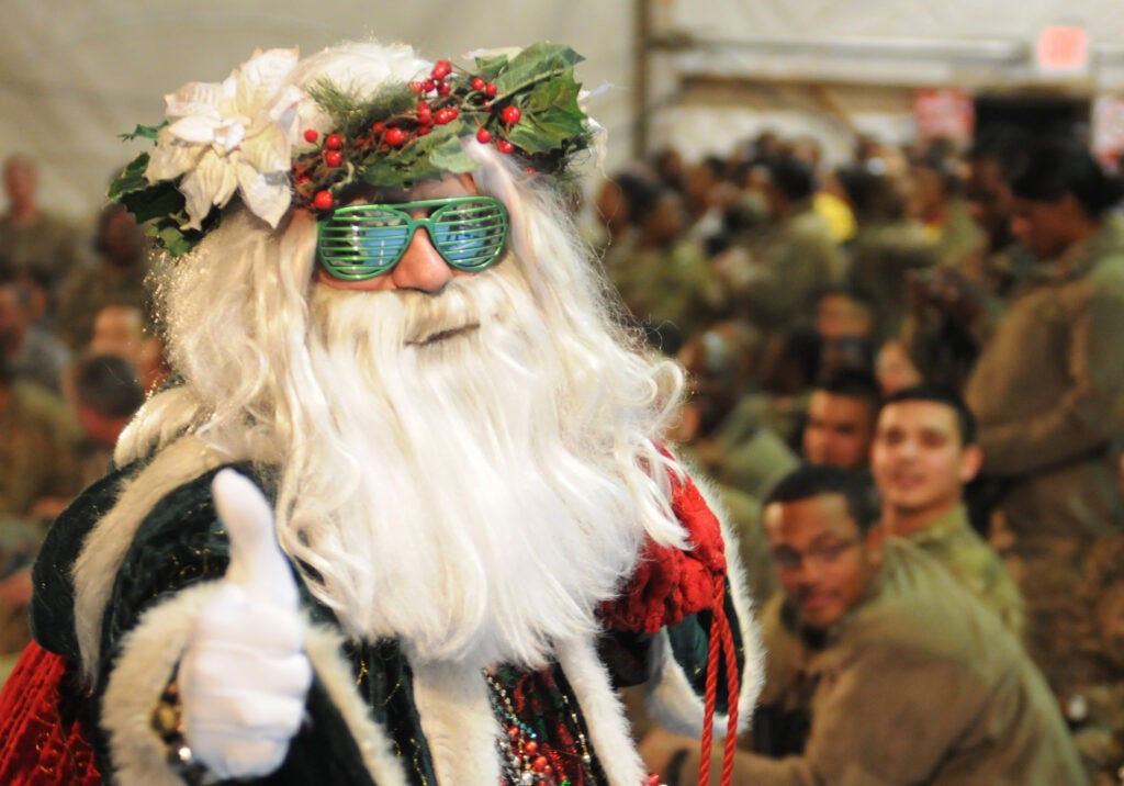 Santa gives a thumbs-up during the USO Holiday Troop Visit Dec. 16. Chairman of Joint Chiefs of Staff General Martin Dempsey led the star-studded group which included singer Jordin Sparks, actress Minka Kelly, former pro-basketball player Robert Horry and comedian Thomas ‘Nephew Tommy’ Miles, to boost morale and deliver some holiday cheer to troops deployed overseas.