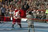 An unmasked John Cena performs a standing fireman's carry takeover on World Wrestling Entertainment Chairman Vince McMahon. Cena had entered the ring as Santa Claus and taunted McMahon, causing McMahon to pull off Cena's beard and hat. (U.S. Army photo/Spc. Michael Howard)