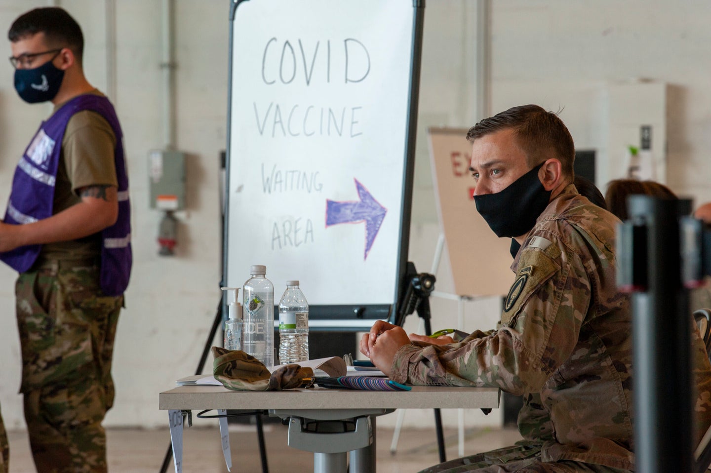 U.S. Army Master Sgt. James E. Loftus, U.S. Special Operations Command Joint Intelligence Center senior enlisted advisor, sits at a checkpoint table at a COVID-19 vaccination distribution site, located on MacDill Air Force Base, Fla., March 12, 2021. Each patient is cross-referenced from a preorganized list to ensure all members are accounted for and that all listed personnel obtain the vaccine. (U.S. Air Force photo by Airman 1st Class David D. McLoney)