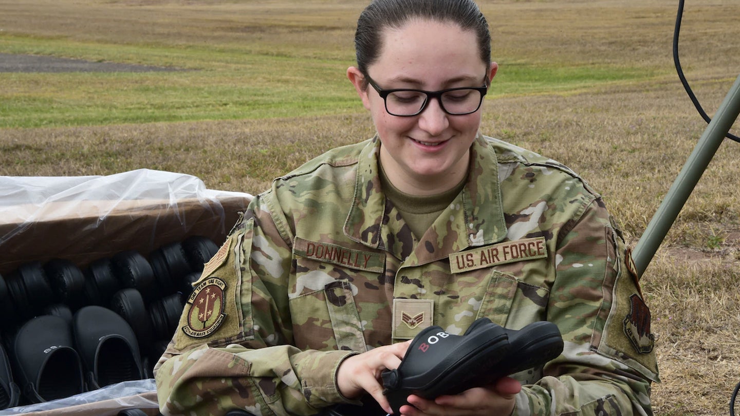 Air Force Senior Airman Britney Donnelly, a weather forecaster assigned to the 612th Air Base Squadron, Joint Task Force Bravo, organizes shoes at Soto Cano Air Base, Honduras, Dec. 16, 2021. Donnelly collected 1,368 pairs of shoes through a nonprofit organization to be donated for children of Comayagua and La Paz. (Air Force photo / Maria Pinel)