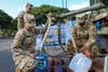 Task Force Ohana Soldiers fill containers with potable water for Aliamanu Military Reservation residents (AMR) at a water supply point at AMR on Dec. 15th, 2021 at AMR, Hawaii.Task Force Ohana Soldiers are currently providing ongoing support to the local residents of Aliamanu Military Reservation and Red Hill housing areas due to affected water supplies and concerns with Services provided to residents include the distribution of freshwater, alternate lodging, medical screening services, and identification of any other resident needs.