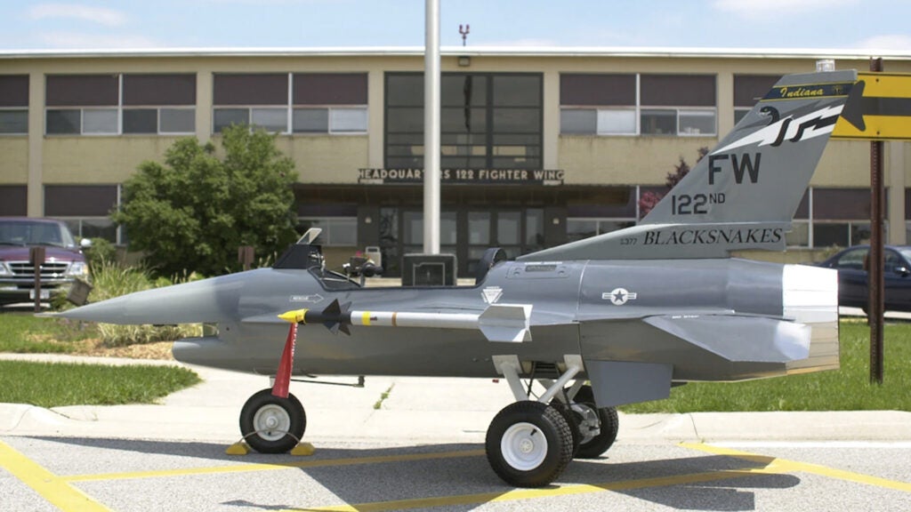 A mini F-16 with the Indiana Air National Guard's 122nd Fighter Wing stands outside the unit's headquarters, complete with mini heads-up display and sidewinder missile. (Air Force photo)