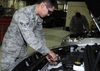 An Air Force vehicle maintainer checks the oxygen sensor on a diesel automobile at RAF Mildenhall.