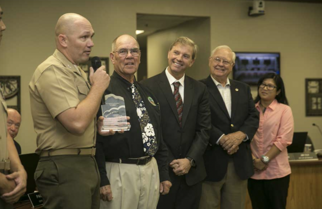 Mojave Desert Air Quality Management District assistant chief of staff Colonel Jay Wylie receives an award for using clean energy and reducing greenhouse gas emissions.