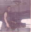 Ron Winter standing next to a .50 caliber machine gun on a CH-46D helicopter in the Vietnam War.