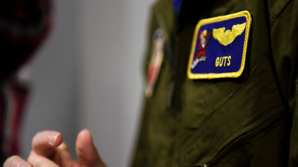 Dylan Bolles-Prasse wears his custom flight suit with a patch featuring his call sign, March 12, 2018, at Seymour Johnson Air Force Base, North Carolina. "GUTS" has a double meaning for Bolles-Prasse, both recognizing his intestinal illness and honoring the way he has approached his ailment and life in general. (U.S. Air Force photo by Staff Sgt. Brittain Crolley)