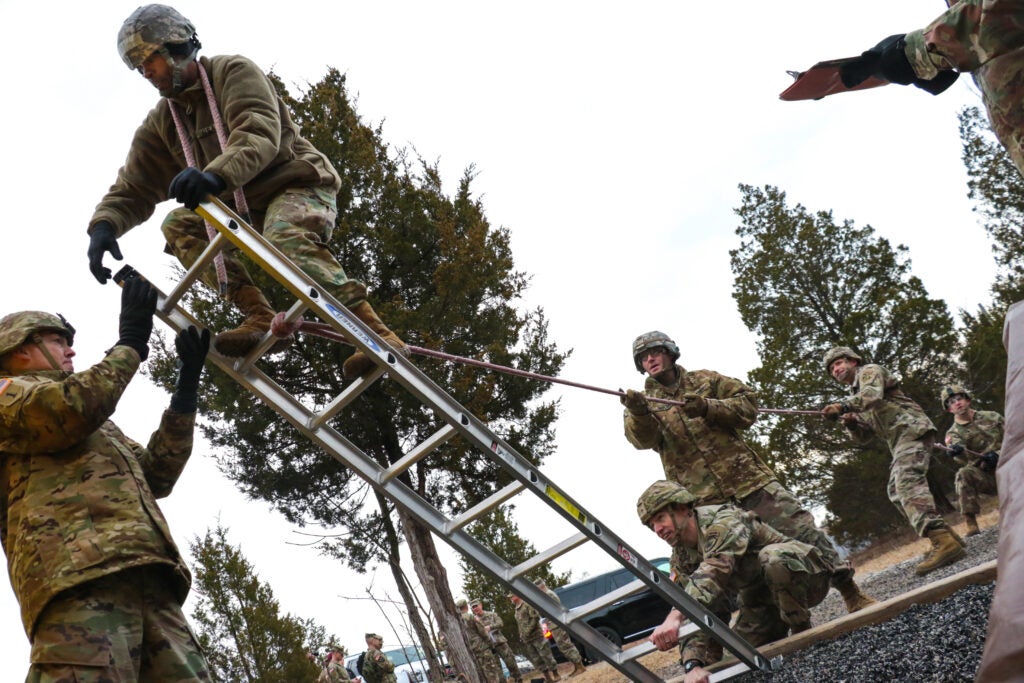 Candidates from cohort 5 attempt to traverse an obstacle at the Leader Reaction Course during the Battalion Commander Assessment Program January 23, 2020, at Fort Knox, Ky. More than 800 officers will complete cognitive and non-cognitive, physical, verbal and written assessments that will provide a more holistic look of an officer before being selected for battalion command. (U.S. Army photo by Staff Sgt. Daniel Schroeder, Army Talent Management Task Force)