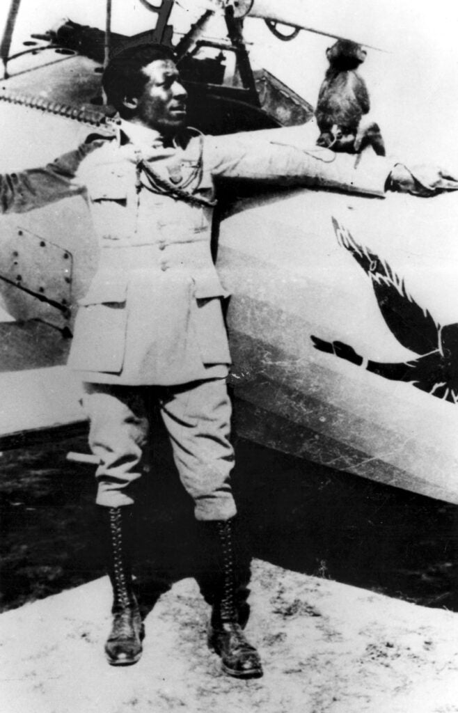 Eugene Bullard with his pet monkey "Jimmy" beside a Nieuport 24 fighter of the 93rd Squadron (Escadrille) in August or September 1917. (U.S. Air Force photo)