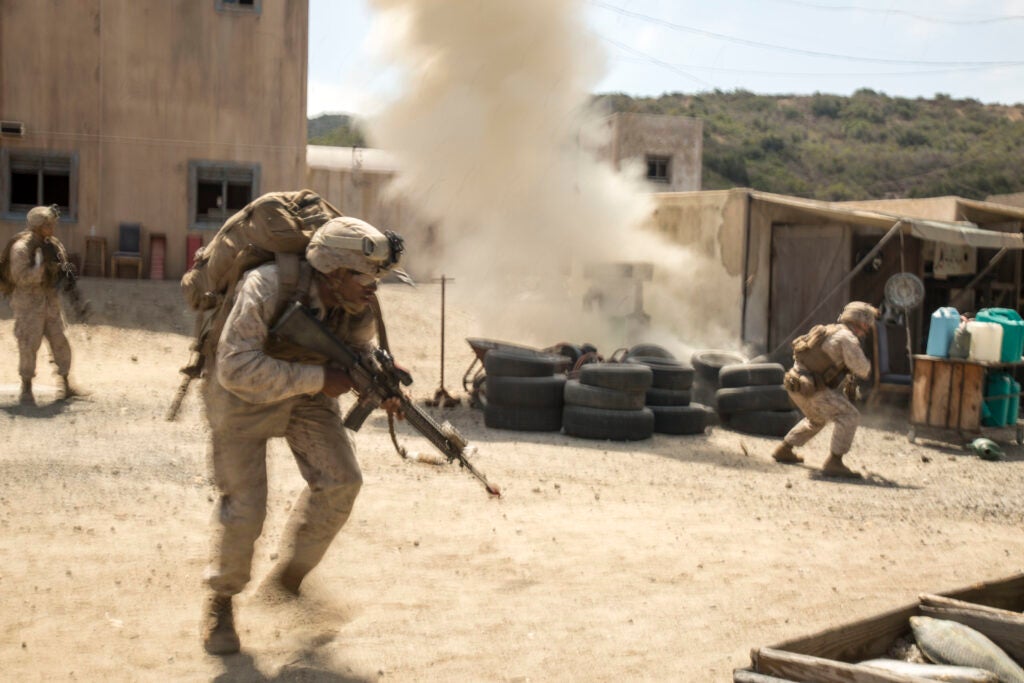 Marines with Company "G", 2nd Battalion, 1st Marine Regiment, react to an improvised explosive device (IED) during a training exercise at the Infantry Immersion Trainer (IIT) aboard Camp Pendleton, Calif., July 31, 2015. The IIT provides a training facility for “hands on” practical application of tactical skills and decision-making in an immersive, scenario-based training environment. (U.S. Marine Corps photo by Sgt Hector de Jesus/Released)