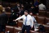 Rep. Ruben Gallego (D-AZ) stands on a chair as lawmakers prepare to evacuate the floor as rioters try to break into the House Chamber at the U.S. Capitol on Wednesday, Jan. 6, 2021, in Washington. (AP Photo/J. Scott Applewhite)