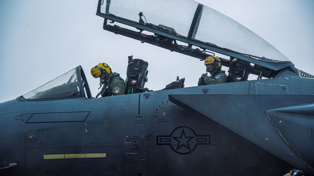 U.S. Air Force Capt. Andrew Gikas, left, 336th Fighter Squadron pilot from Seymour Johnson Air Force Base, N.C., and Capt. Sam Simmons, right, 336 FS weapons systems officer, perform preflight checks while practicing alert launches at Ämari Air Base, Estonia, Jan. 27, 2022 (U.S. Air Force photo by Staff Sgt. Megan M. Beatty)