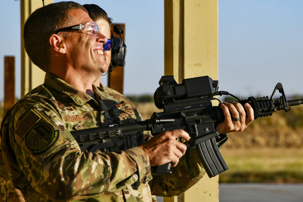 Col. Andrew Clark, 9th Reconnaissance Wing commander, tests the Smart Shooter sighting device with Staff Sgt. Colton Becker, 9th Security Forces Squadron training flight, during a demonstration at Beale Air Force Base, California, Aug. 14, 2019. The 9th SFS Airmen have been using off the shelf commercial technology to help train and improve how their missions are conducted to protect the installation. (U.S. Air Force photo by Tech. Sgt. Alexandre Montes)