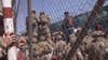 This image from a video released by the Department of Defense shows U.S. Marines at Abbey Gate before a suicide bomber struck outside Hamid Karzai International Airport on Aug. 26, 2021, in Kabul Afghanistan. The military investigation into the deadly attack during the Afghanistan evacuation has concluded that a suicide bomber, carrying 20 pounds of explosives packed with ball bearings, acted alone, and that the deaths of more than 170 Afghans and 13 U.S. service members were not preventable. (Department of Defense via AP)