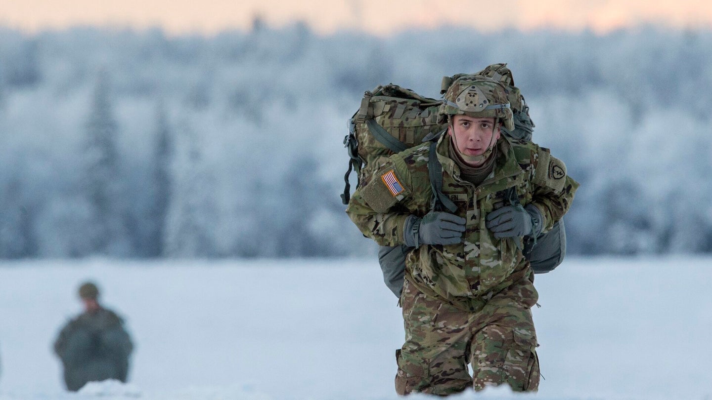 A soldier with the 4th Infantry Brigade Combat Team (Airborne), 25th Infantry Division, proceeds to the rally point after completing an airborne training jump at Joint Base Elmendorf–Richardson, Alaska, in January 2018. (U.S. Air Force photo by Alejandro Peña, Joint Base Elmendorf–Richardson Public Affairs)