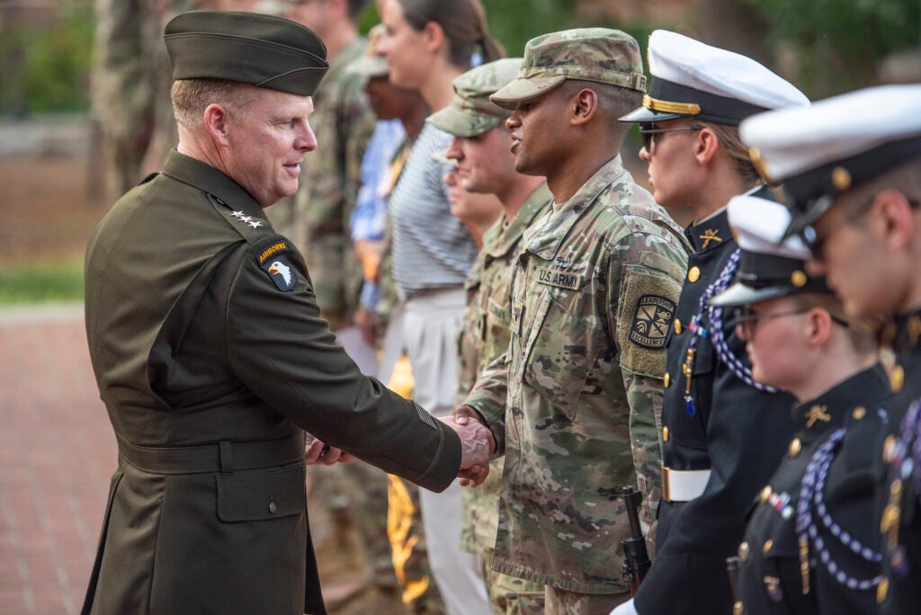 Lieutenant General Duane A. Gamble, U.S. Army Deputy Chief of Staff., hands out his challenge coins to Clemson University Army ROTC cadets after a 9/11 remembrance ceremony in the university’s Military Heritage Plaza, Sept. 14, 2021. The ceremony was sponsored by Clemson’s Army ROTC Tiger Platoon. (Photo by Ken Scar)