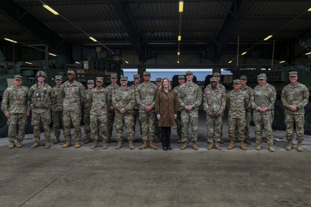 The Honorable Christine Wormuth, U.S. Secretary of the Army, poses for a photo with a group of U.S. Army 2d Cavalry Regiment Soldiers after being awarded a challenge coin by Wormuth Oct. 27, 2021, Grafenwoehr Training Area, Germany. Wormuth visited Germany on behalf of the U.S. Army to show the 75 years of our strong alliance. Soldiers from 2CR shared with Wormuth their lessons and experiences with their field equipment and training with their partnering nations as part of NATO inoperability. (U.S Army photo by Pfc. Jesus Menchaca)