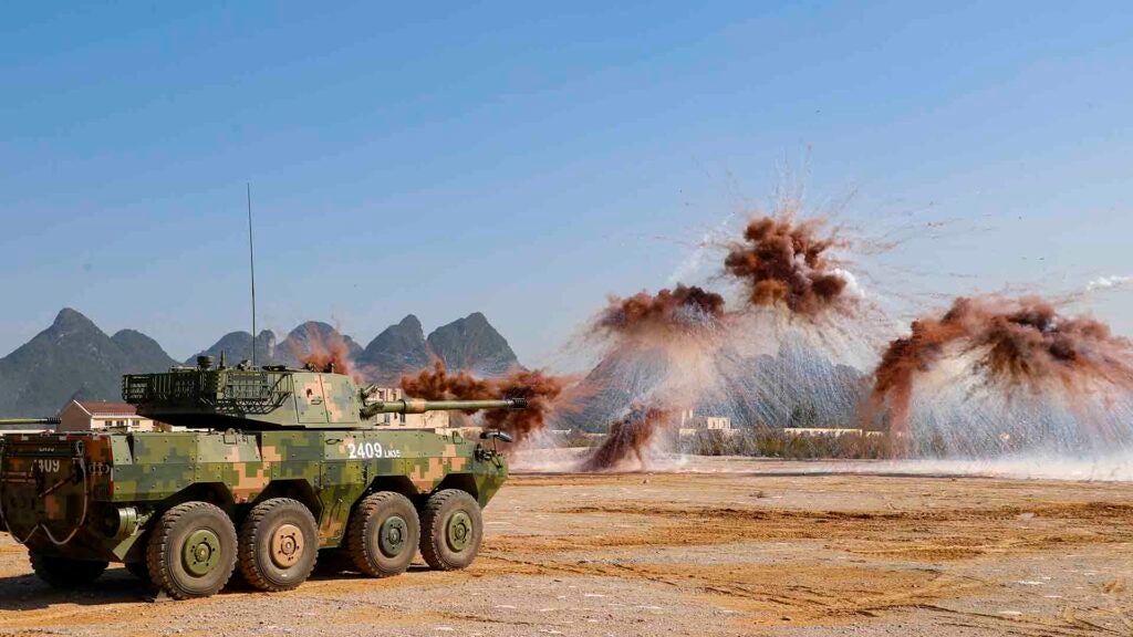 GUILIN, CHINA - NOVEMBER 30: Armored assault vehicles of the People's Liberation Army fire smoke bombs to test new weaponry on November 30, 2021 in Guilin, Guangxi Zhuang Autonomous Region of China. (Photo by Huang Yuanli/VCG via Getty Images)