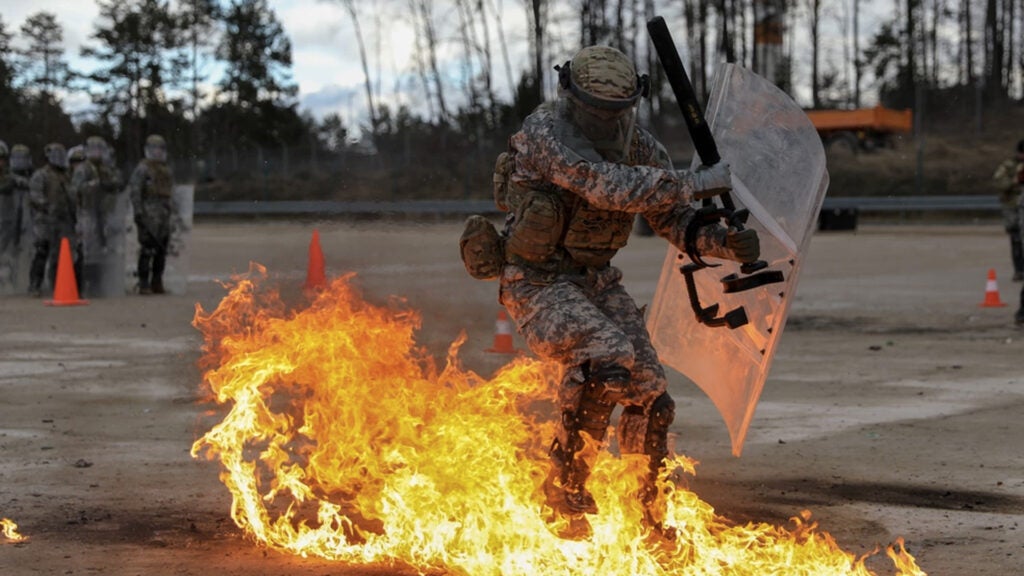 A U.S. Army Soldier assigned to Kentucky National Guard’s 1st Battalion, 149th Infantry Brigade, 116th Infantry Brigade Combat Team, 29th Infantry Division, reacts to a Molotov cocktail while undergoing fire phobia training at the Joint Multinational Readiness Center, Hohenfels, Germany, Feb. 11, 2022 (U.S. Army photo by Sgt. Marla Ogden)