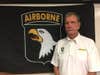 Dallas Brown, a Vietnam War veteran who served with Company A, 2nd Battalion, 327th Infantry Regiment, 1st Brigade [Separate], 101st Airborne Division poses next to a Screaming Eagle Flag, Aug 8, 2017, at Fort Campbell, Kentucky. Brown, along with Tim Winterburg , Watson Baldwin, and Jay Cope,  is one of the Soldiers pictured in the famous Vietnam War photograph “Help from Above” by Art Greenspon. When the photo was taken, Brown  was laying on the ground grimacing in pain from an injury sustained during a firefight with the NVA. (U.S Army Photo by Sgt. William White)