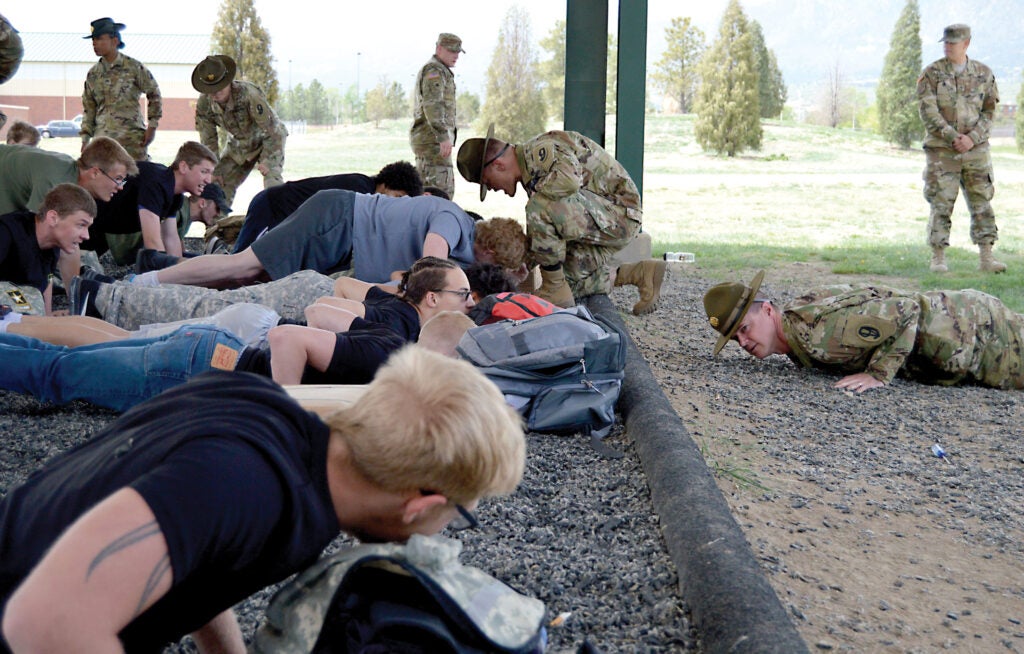FORT CARSON, Colo. — 415th Infantry Regiment Army Reserve drill sergeants instruct future Soldiers on proper pushup techniques during the Future Soldier Mega Event at Pershing Field May 12, 2018. (Photo by Scott Prater)