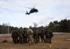 Paratroopers assigned to the 82nd Airborne Division and Polish soldiers assigned to the 21st Rifle Brigade watch a U.S. HH-60 Blackhawk helicopter land during a multi-national training event in Nowa Deba, Poland, Feb. 22, 2022. The focus of the 82nd Airborne Division's mission is to assure our Allies and partners and deter aggression as they have a host of unique capabilities and conduct a wide range of missions that are scalable and tailorable to mission requirements. (U.S. Army Photo by Master Sgt. Alexander Burnett)
