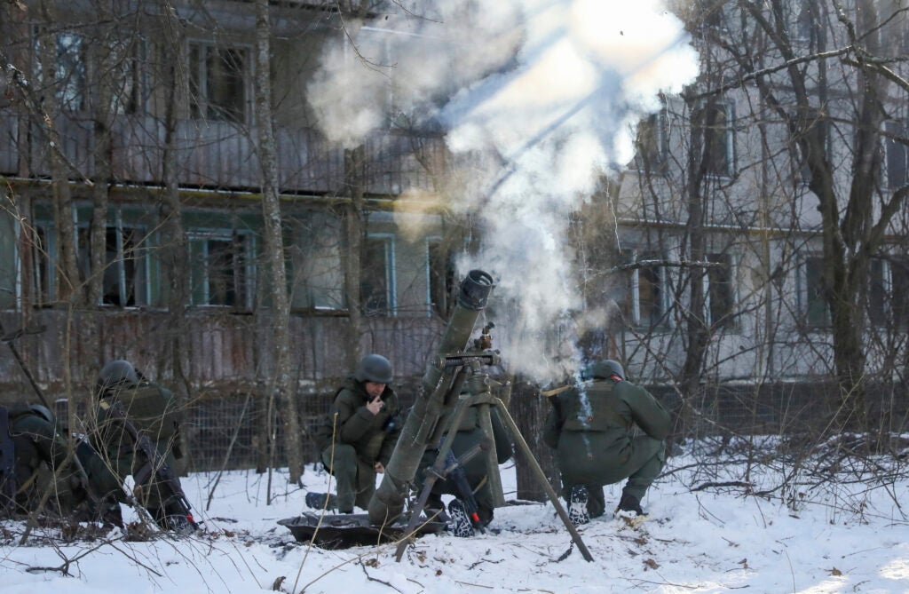 The National Guard soldiers take part in tactical exercises, which are conducted by the Ukrainian National Guard, Armed Forces, special operations units and simulate a crisis situation in an urban settlement, in the abandoned city of Pripyat near the Chernobyl Nuclear Power Plant, Ukraine, Friday, Feb. 4, 2022. (AP Photo/Mykola Tymchenko)