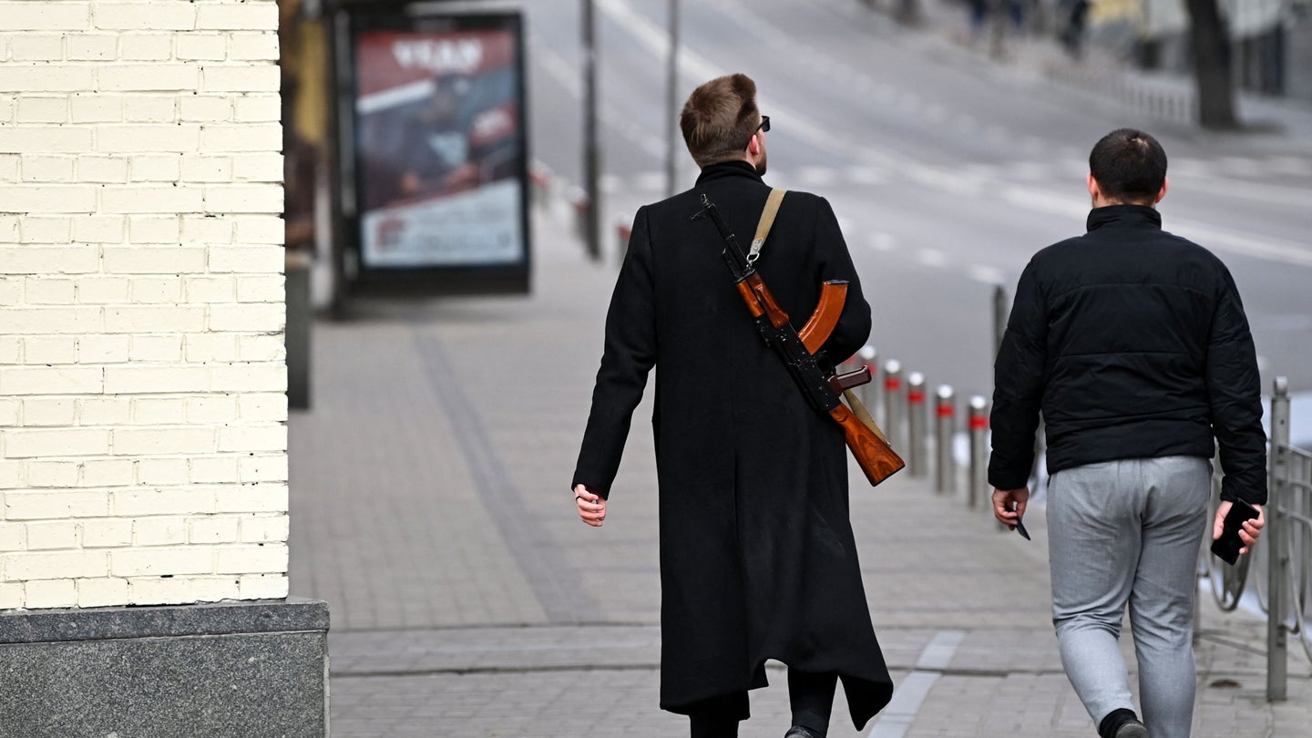 A man carrying a Kalashnikov AK-47 rifle walks in central Kyiv on February 25, 2022. (Photo by Daniel LEAL / AFP) (Photo by DANIEL LEAL/AFP via Getty Images)