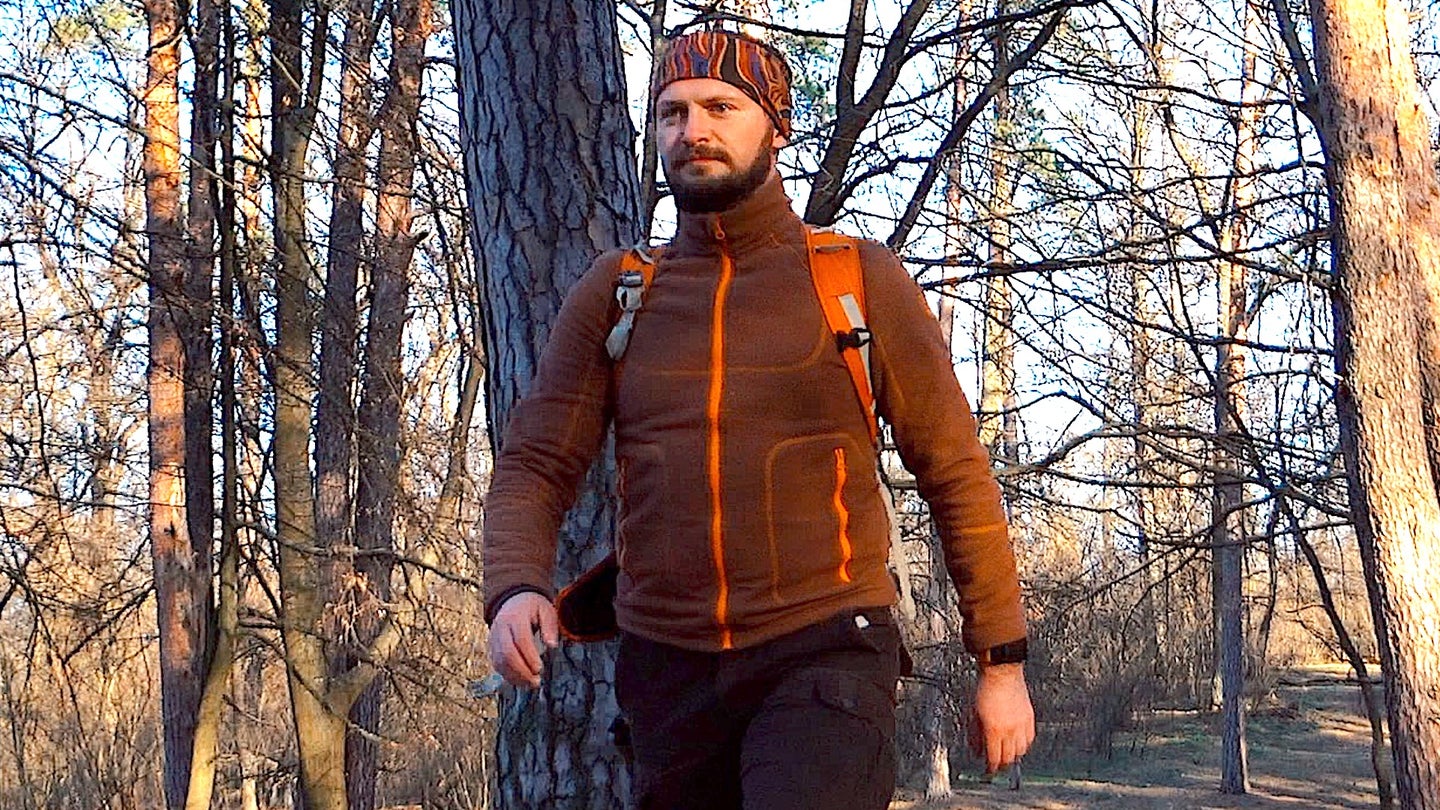 A man hiking in a fleece jacket.