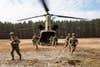 U.S. Paratroopers assigned to 3rd Brigade Combat Team, 82nd Airborne Division, exit a CH-47 Chinook during an air assault training event with their Polish Allies in Nowa Deba, Poland, March 3, 2022. The focus of the 82nd Airborne Division's mission is to assure our Allies by providing a host of unique capabilities and conducting a wide range of missions that are scalable and tailorable to mission requirements. (U.S. Marine Corps photo by Sgt. Claudia Nix)