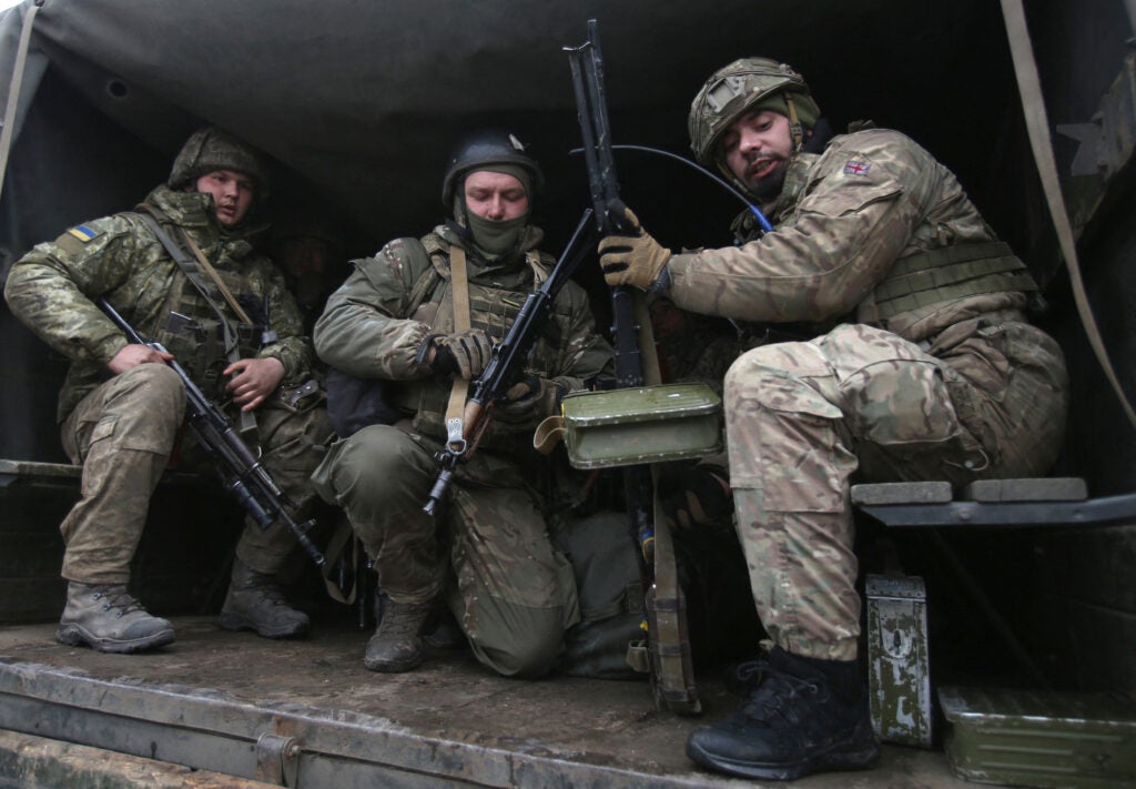 Servicemen of Ukrainian Military Forces move to their position prior to the battle with Russian troops and Russia-backed separatists in Luhanskregion on March 8, 2022. - The number of refugees flooding across Ukraine's borders to escape towns devastated by shelling and air strikes passed two million, in Europe's fastest-growing refugee crisis since World War II, according to the United Nations. (Photo by Anatolii Stepanov / AFP) (Photo by ANATOLII STEPANOV/AFP via Getty Images)