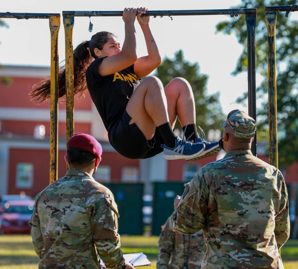 U.S. Army Spc. Genesis Miranda, assigned to 55th Signal Company (Combat Camera), completes the leg tuck event of the Army Combat Fitness test for the Headquarters, Department of the Army Best Warrior Competition on Fort George G. Meade, Maryland, Sept 19, 2020. The Best Warrior recognizes Soldiers who demonstrate commitment to the Army values, embody the Warrior Ethos, and represent the Force of the Future. (U.S. Army photo by Spc. Kivahzi Bell)
