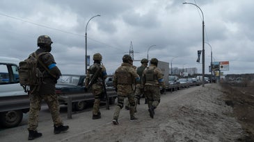 Ukrainian Soldiers Walks Toward The Frontline Near Irpin