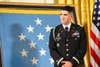 Retired U.S. Army Capt. Florent Groberg listens as President Barack Obama addresses the audience during a Medal of Honor Ceremony for at the White House in Washington, Nov. 12, 2015. Groberg received the medal for actions during a combat engagement in Kunar province, Afghanistan, Aug. 8, 2012, while he was the commander of a personal security detail for the 4th Brigade Combat Team, 4th Infantry Division, when he and another Soldier, Sgt. Andrew Mahoney, identified and tackled a suicide bomber, saving the lives of the brigade commander and several others. (U.S. Army photo by Eboni L. Everson-Myart)