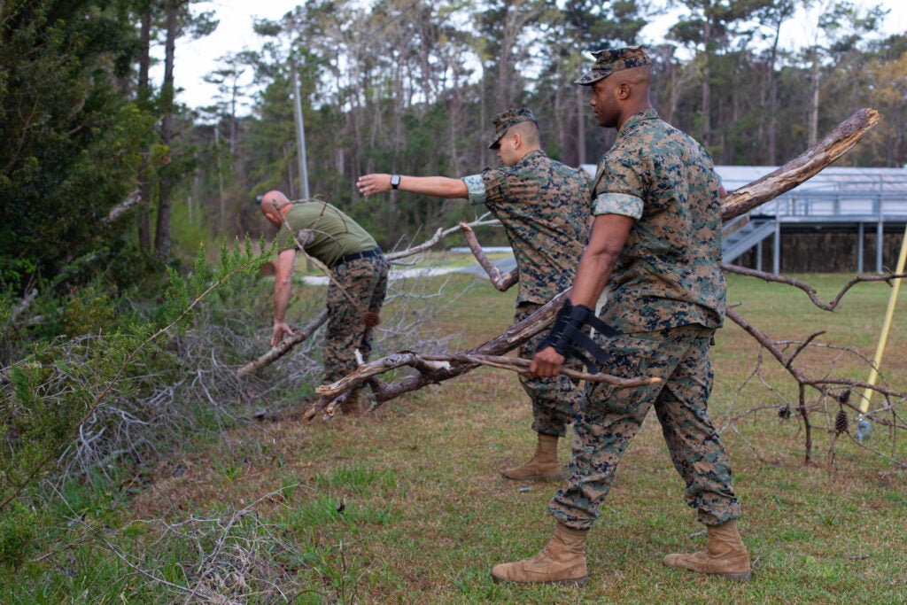 U.S. Marines with Marine Corps Combat Service Support Schools (MCCSSS) clear out large debris during a base-wide clean-up on Camp Johnson, N.C. March 22, 2022. To commemorate Earth Day 2022, Marines of MCCSSS organized the removal of safety hazards, trash, and maintained Camp Johnson’s state of cleanliness. (U.S. Marine Corps photo by Lance Cpl. Tanner M. Pittard)