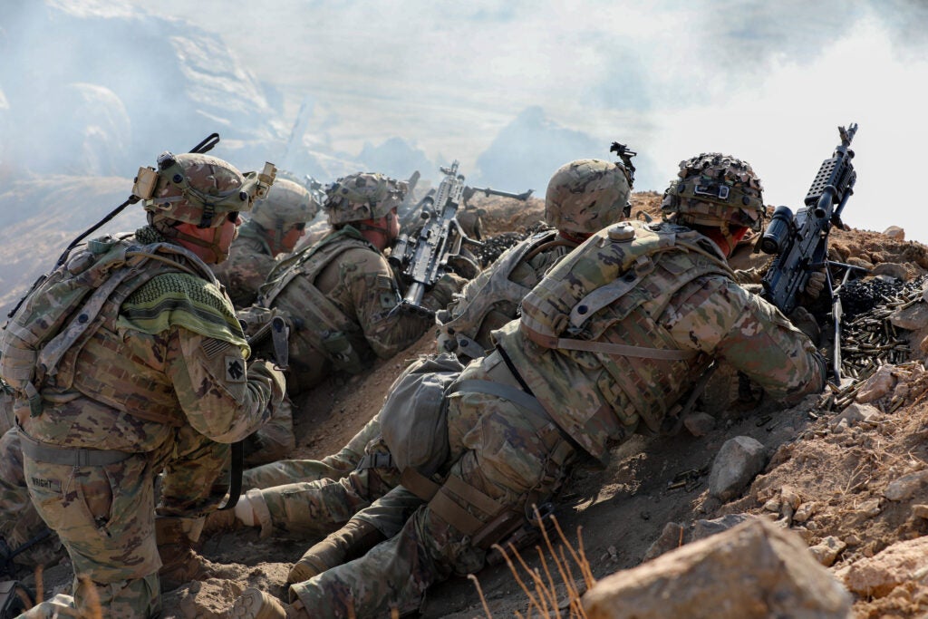 Soldiers with the 45th Infantry Brigade Combat Team fire weapons over a trench during a live-fire exercise at the National Training Center in Fort Irwin, California, July 24, 2021. Members of the 45th IBCT participated in a live fire exercise in the mountains of the Mojave Desert with the intention of increasing their proficiency. (Oklahoma Army National Guard photo by Pfc. Emily White)