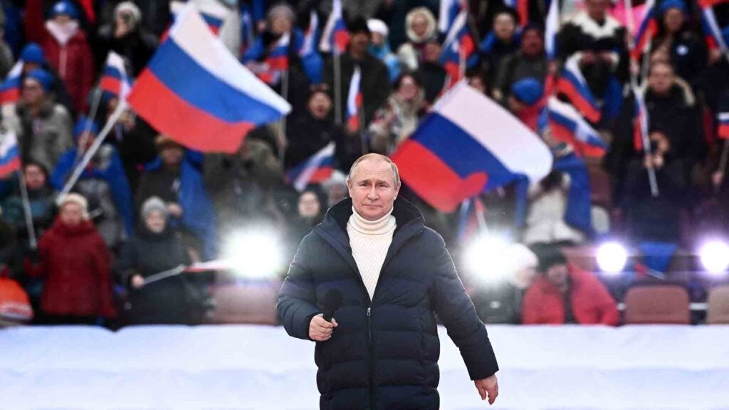 TOPSHOT - Russian President Vladimir Putin attends a concert marking the eighth anniversary of Russia's annexation of Crimea at the Luzhniki stadium in Moscow on March 18, 2022. (Photo by Sergei GUNEYEV / POOL / AFP) (Photo by SERGEI GUNEYEV/POOL/AFP via Getty Images)