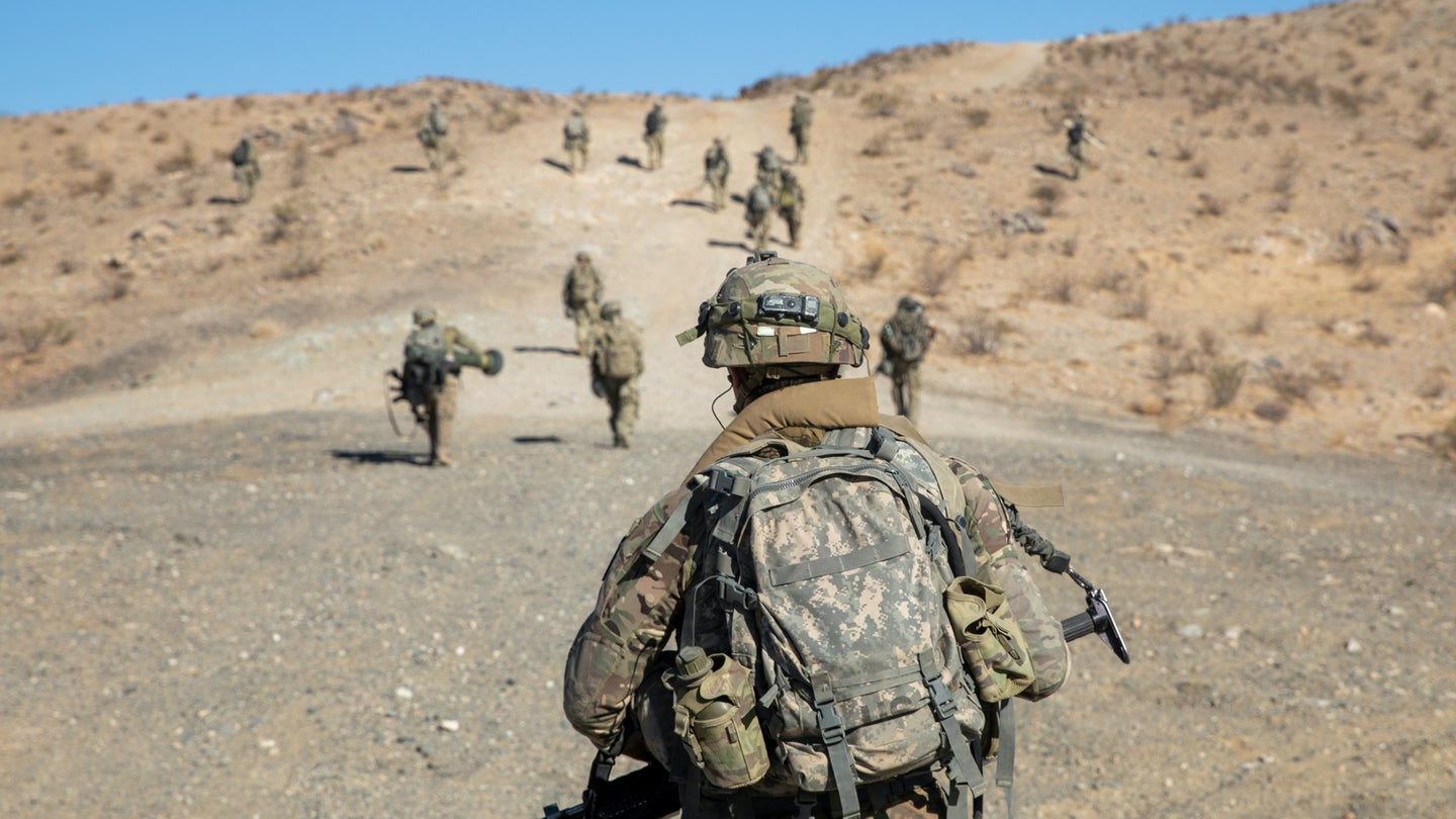 Soldiers of the 1st Battalion, 297th Infantry Regiment, Wyoming Army National Guard, advance to an objective during a training exercise at the National Training Center, Fort Irwin, California, June 12, 2021. (Mississippi Army National Guard/Cdt. Jarvis Mace)