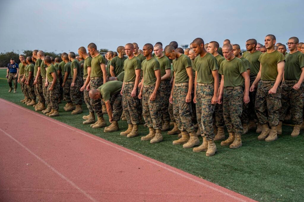 U.S. Marine recruits with Lima Company, 3rd Recruit Training Battalion, wait in groups to run during a combat fitness test (CFT) at Marine Corps Recruit Depot, San Diego, Sept. 24, 2021. Recruits ran 880 meters to simulate a movement to contact. The CFT was conducted to test and score recruits’ level of combat fitness. (U.S. Marine Corps photo by Cpl. Grace J. Kindred)