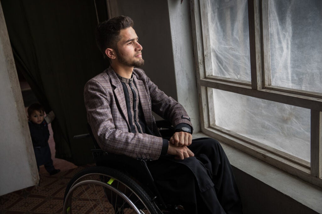 Shabir at home in Jalalabad, Afghanistan, on March 11. He was partially paralyzed from the waist down. (Oriane Zerah for ProPublica)