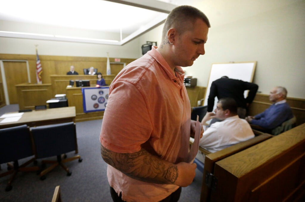 In this Tuesday, Dec. 10, 2013 photo, Edward Cowen, 26, of Boston, a Marine Corps infantry veteran who did two tours overseas including Iraq and Bahrain, departs Veterans Treatment Court following a hearing, in Dedham, Mass.  A growing number of cities are holding special court sessions to help veterans get back on their feet. In Dedham, the first class of veterans graduated last month from a 2-year program. (AP Photo/Steven Senne)