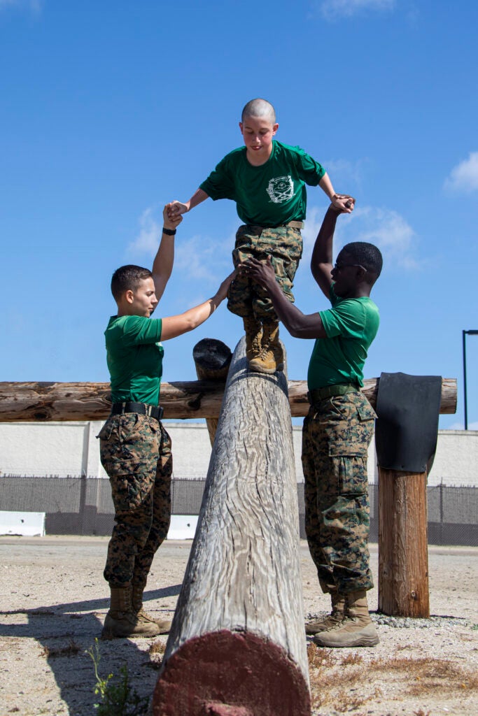 Marines with Support Battalion, Recruit Training Regiment, Marine Corps Recruit Depot (MCRD) San Diego guide Wyatt, a child with the Make-a-wish foundation, through the confidence course at MCRD San Diego, March 30, 2022. The depot was in full support of the Make-a-Wish foundation in granting Wyatt’s wish to be a Marine for a day (U.S. Marine Corps photo by LCpl. Cristian G. Torres.)