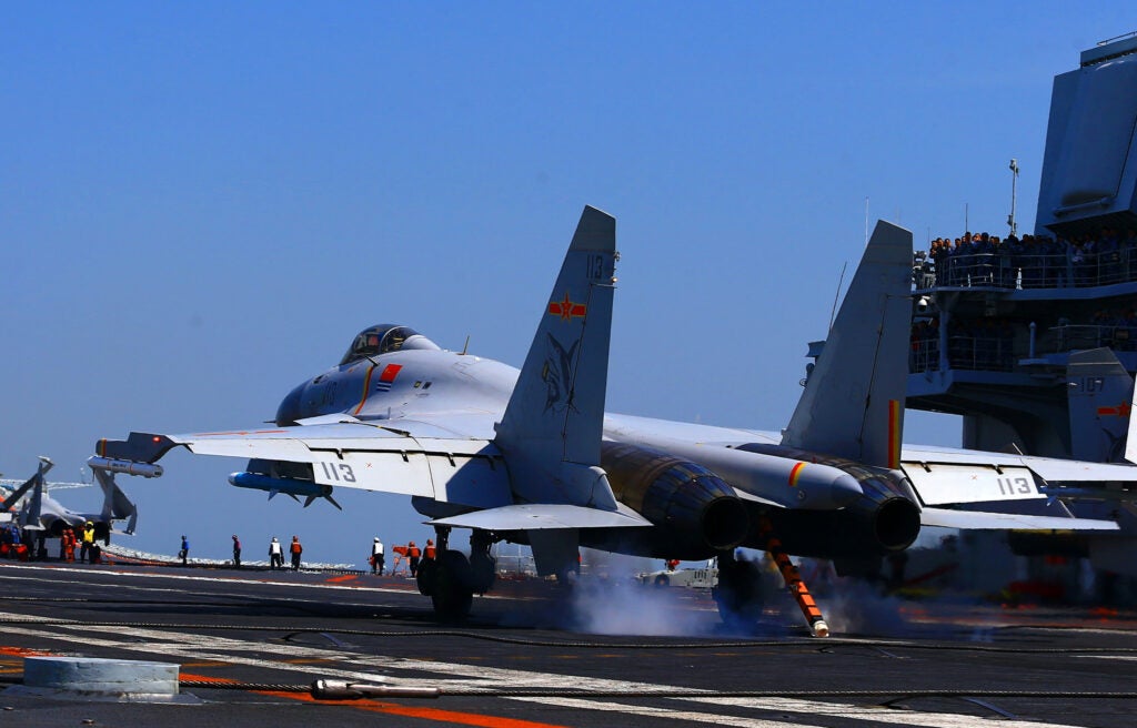 This photo taken on April 24, 2018 shows a J15 fighter jet landing on China's sole operational aircraft carrier, the Liaoning, during a drill at sea. - A flotilla of Chinese naval vessels held a "live combat drill" in the East China Sea, state media reported early April 23, 2018, the latest show of force by Beijing's burgeoning navy in disputed waters that have riled neighbours. (Photo by - / AFP) / China OUT        (Photo credit should read -/AFP via Getty Images)